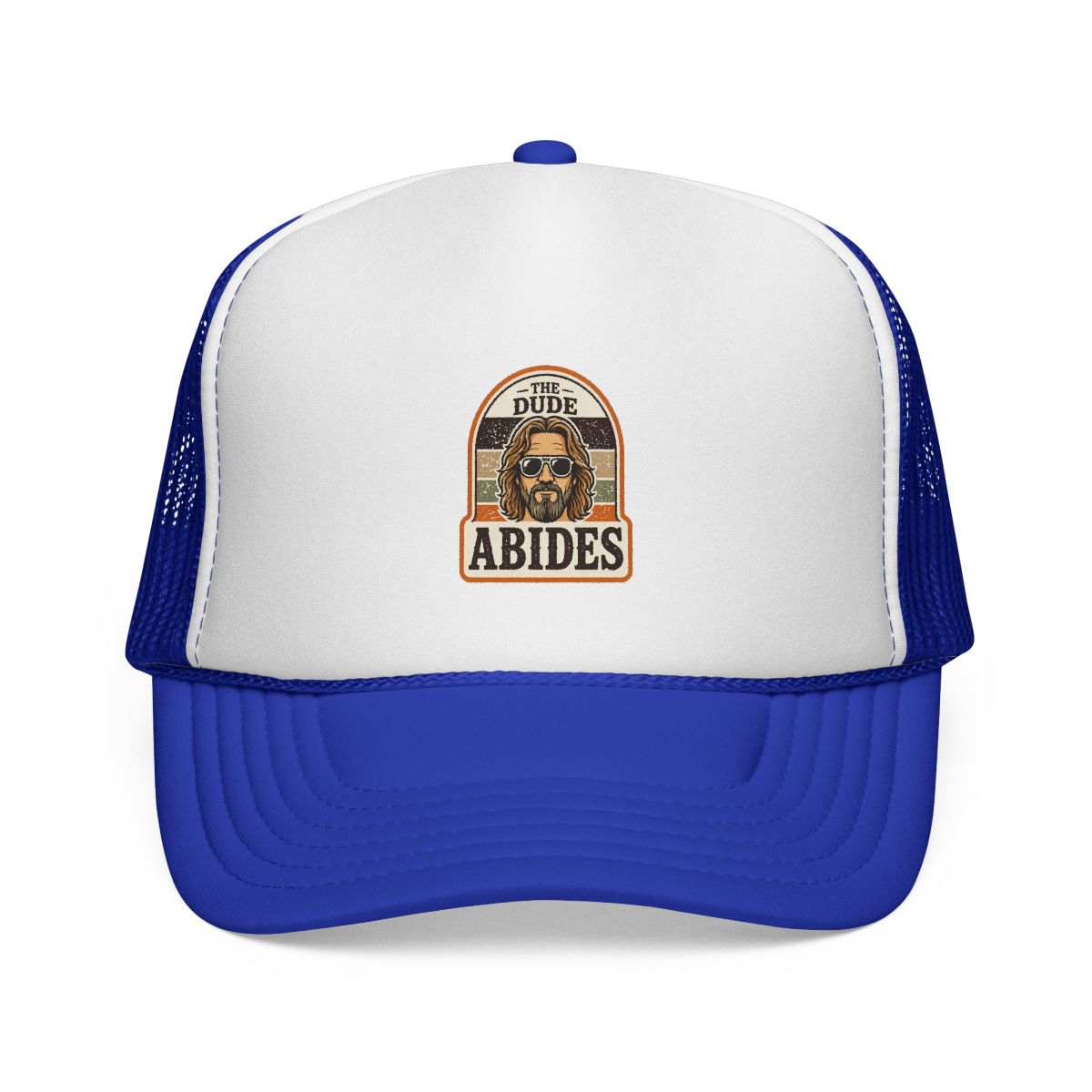 A brown and white trucker hat with a patch that says "The Dude Abides" and features a cartoon image of a man wearing sunglasses - alternate angle 4, merchandise