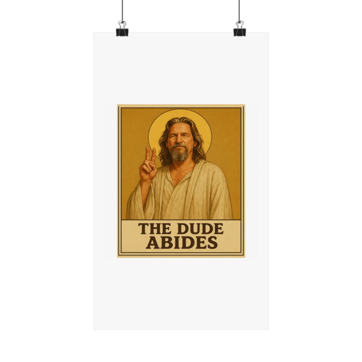 Framed poster depicting a man with long hair and a beard, dressed in a robe, giving a peace sign. A golden halo is behind him. The text "THE DUDE ABIDES" is at the bottom of the poster - alternate angle 5, merchandise
