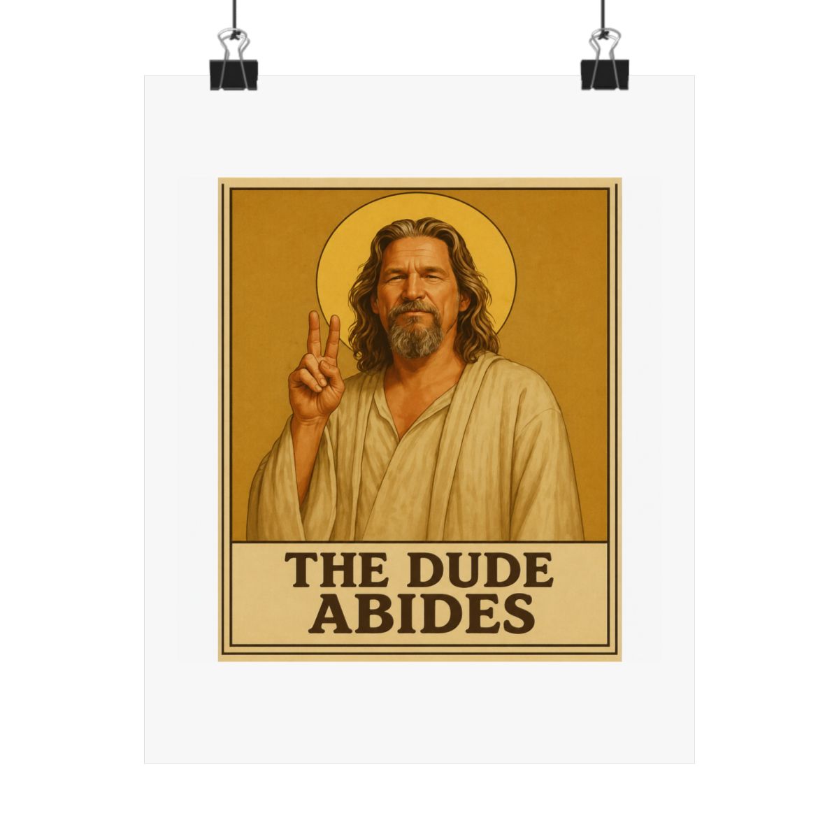 Framed poster depicting a man with long hair and a beard, dressed in a robe, giving a peace sign. A golden halo is behind him. The text "THE DUDE ABIDES" is at the bottom of the poster