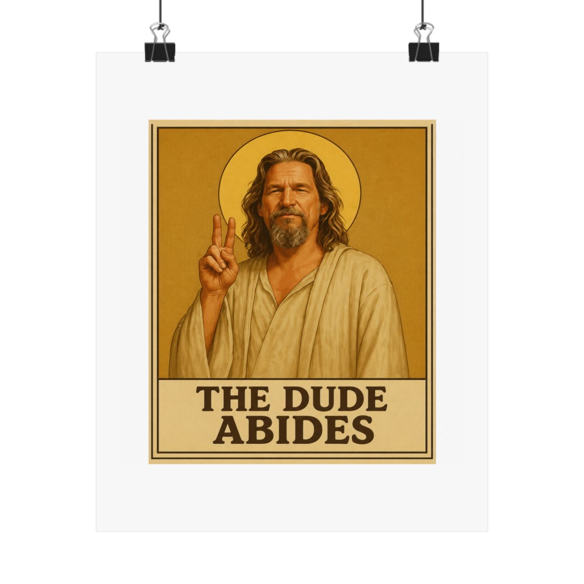 Framed poster depicting a man with long hair and a beard, dressed in a robe, giving a peace sign. A golden halo is behind him. The text "THE DUDE ABIDES" is at the bottom of the poster - alternate angle 3, merchandise